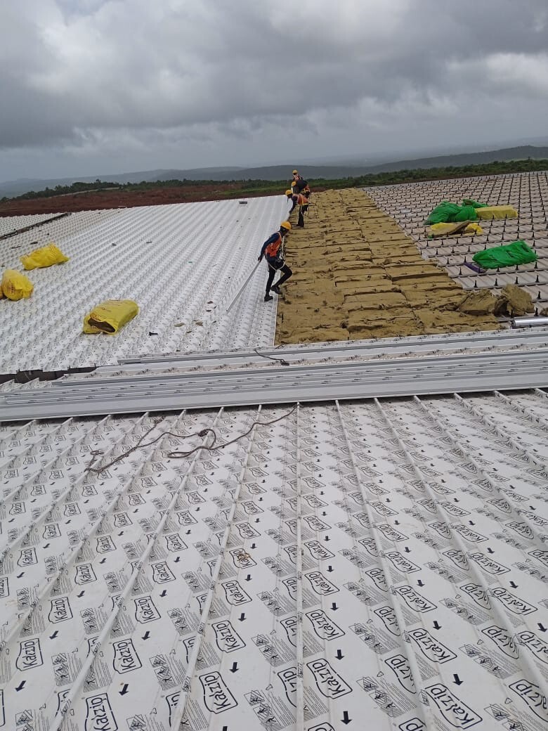 Commercial architectural roofing at Oberoi Mall, Mumbai: Specialized Kliplok roof-on-roof installation by Rishonn & Reyansh for leak-proof retail infrastructure.